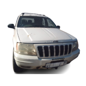 2002 Jeep Grand Cherokee 4.7 WJ being stripped for spares, showing removed engine parts, body panels, interior components, and suspension elements.