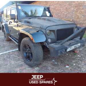 2015 Jeep Wrangler 2.8 JK in the process of being stripped for spares, with parts like the engine, doors, and interior components removed and displayed.